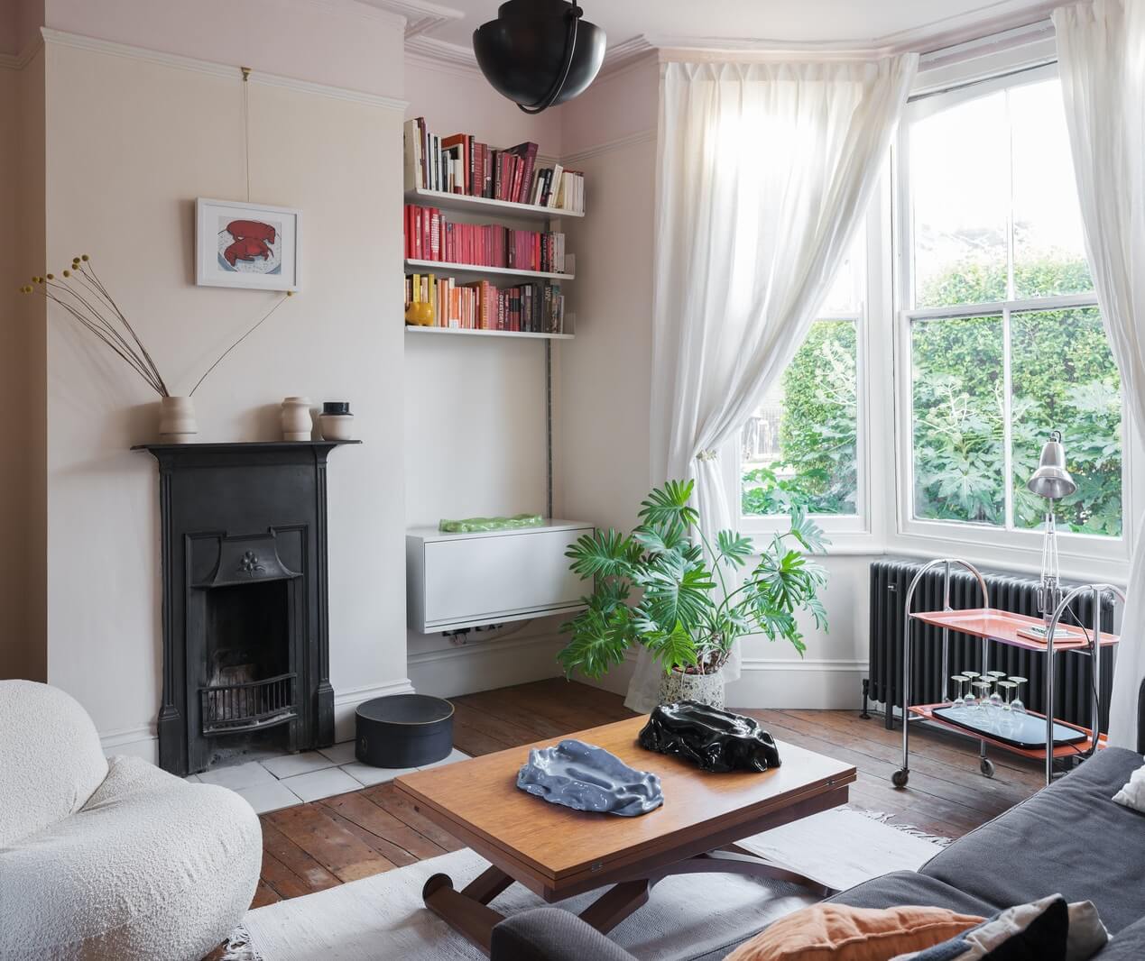 A London Home with Green Color Accents 2 black fireplace in living room
