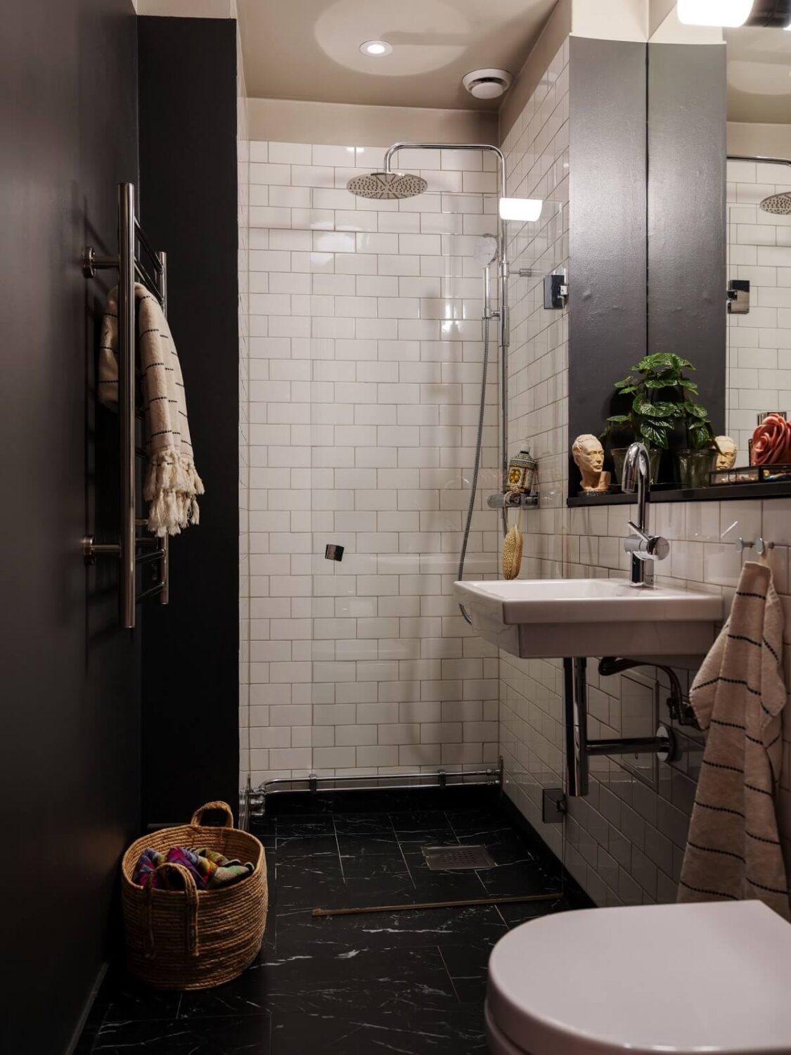 A Muted Color Palette in a Scandinavian Apartment 17 black white bathroom with shower