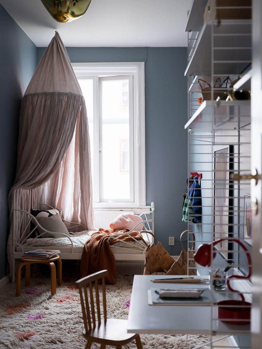 A Beautiful Color Palette in a Scandinavian Family Apartment 32 blue children bedroom with canopy and desk nordroom