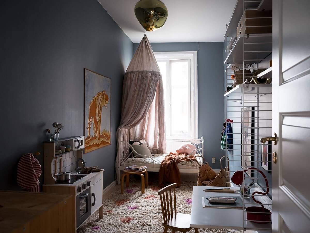 A Beautiful Color Palette in a Scandinavian Family Apartment 31 blue child's bedroom with string shelves desk