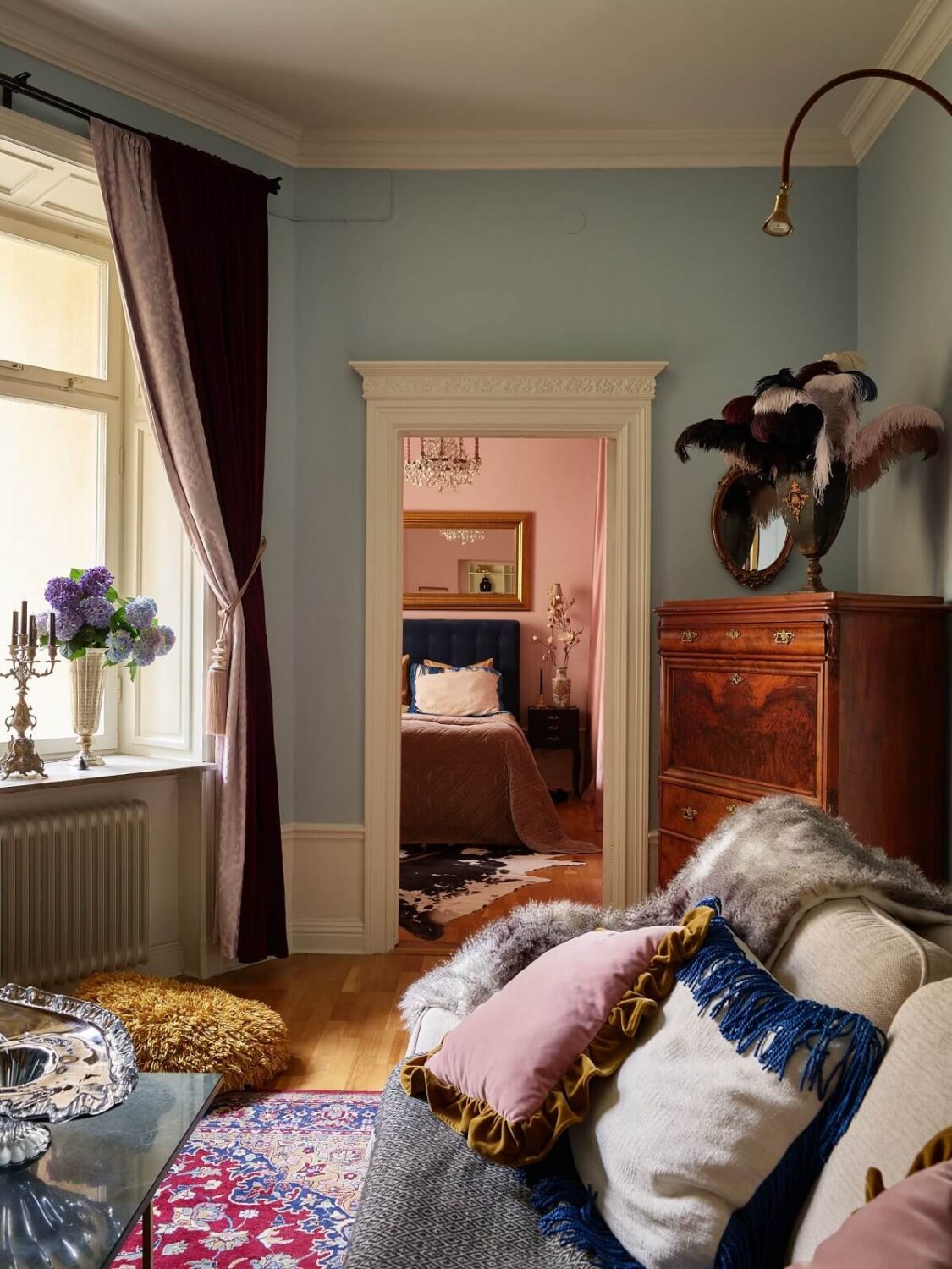 A Classic & Cozy Apartment Painted in Pastel Pink and Blue 7 blue-living-room-with-attached-pink-bedroom-nordroom