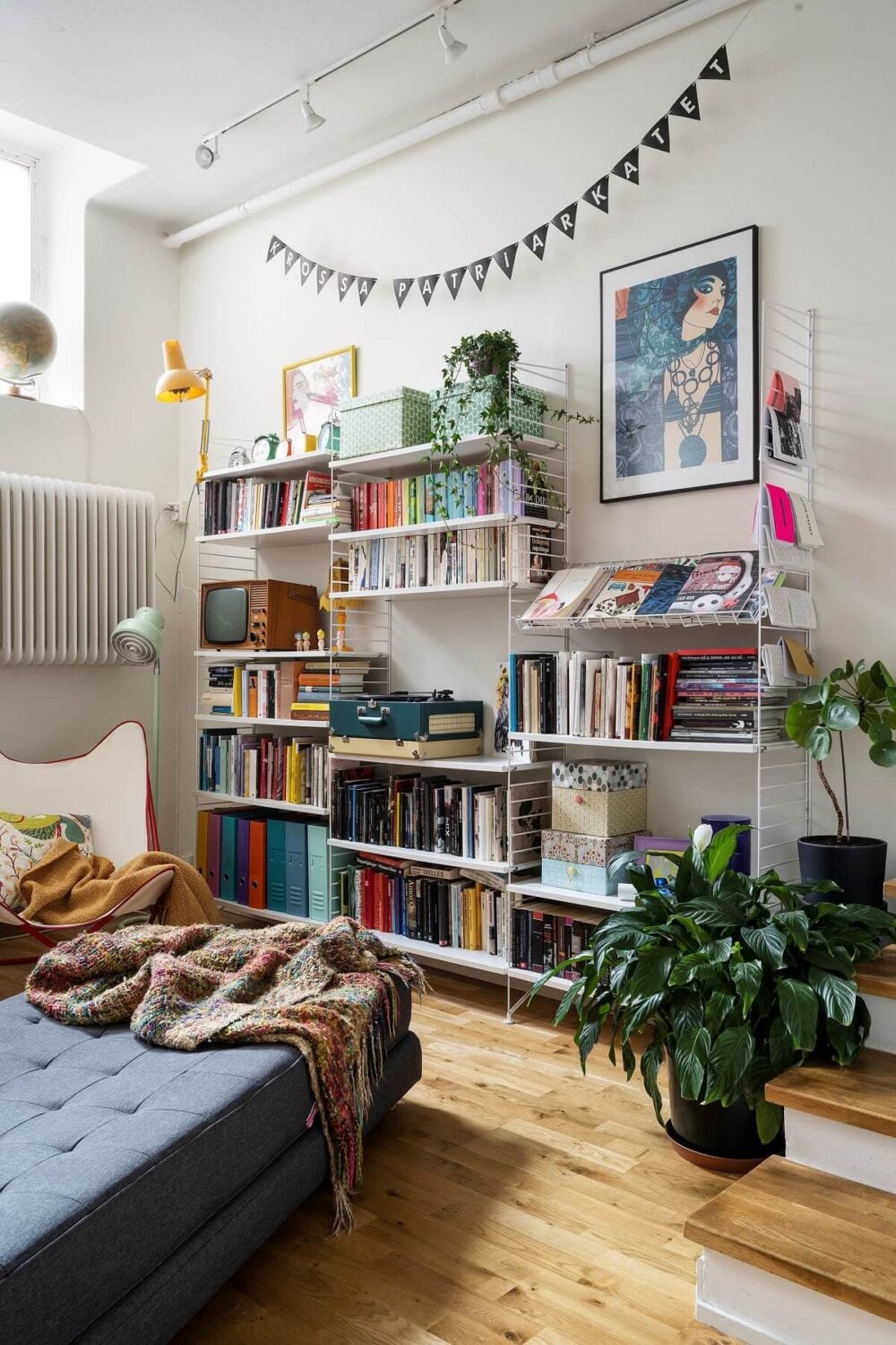 A Basement Family Apartment with Colorful Furniture and Decor 6 bookshelves in loft style living room