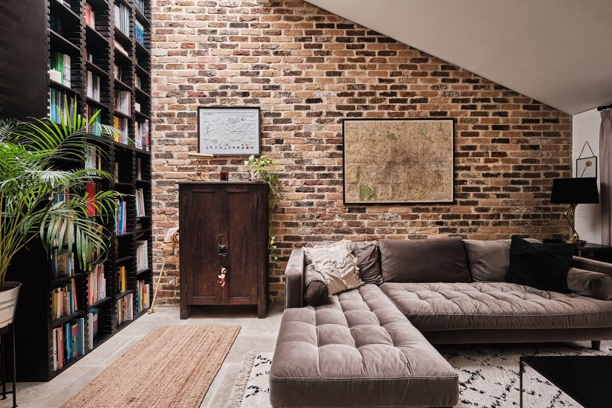 A London Warehouse Conversion with a Black deVOL Kitchen 2 brick wall and floor to ceiling bookcases in living room