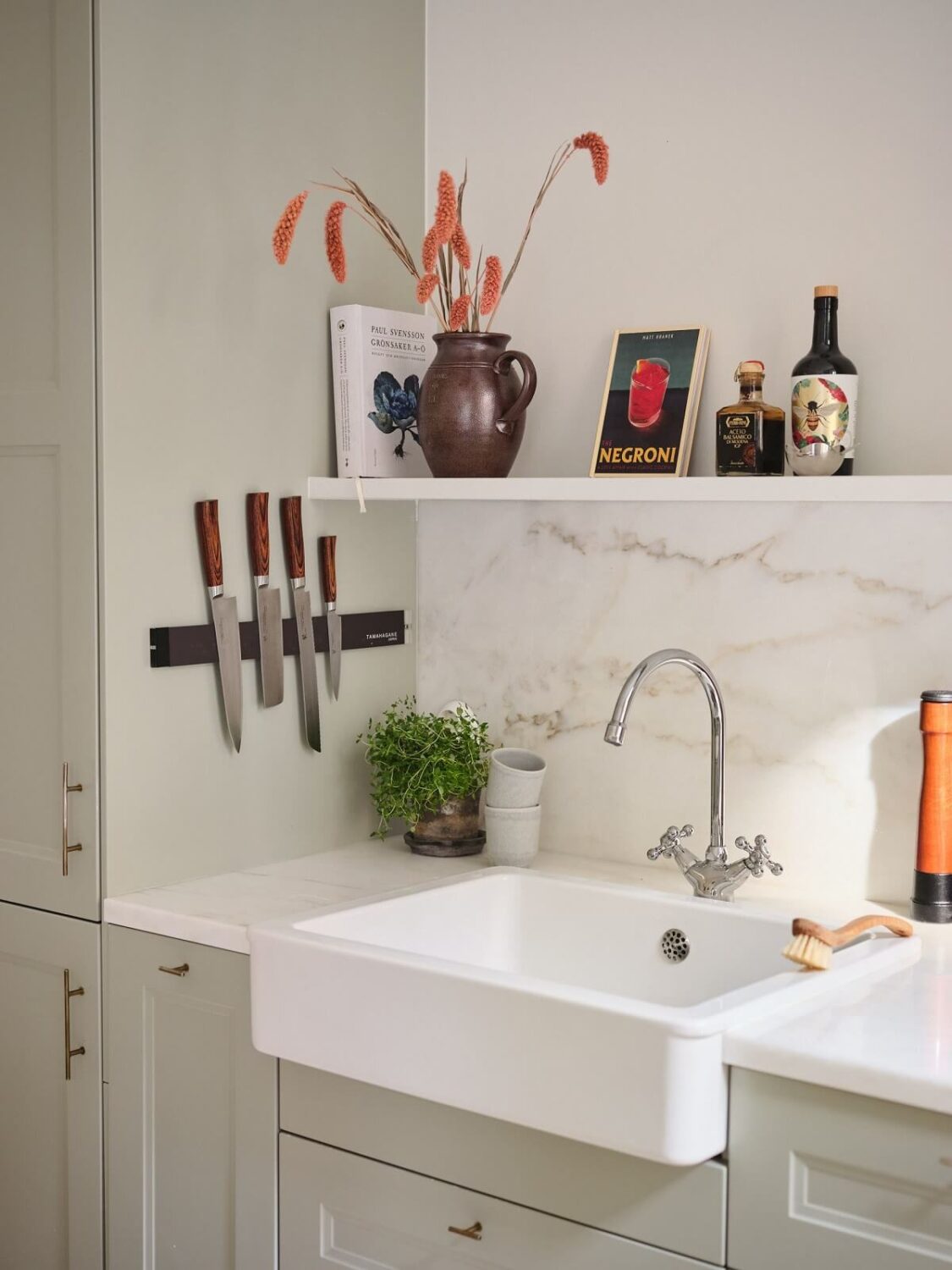 A Light Filled Duplex Apartment in Sweden 7 butler sink in light gray kitchen with shelf