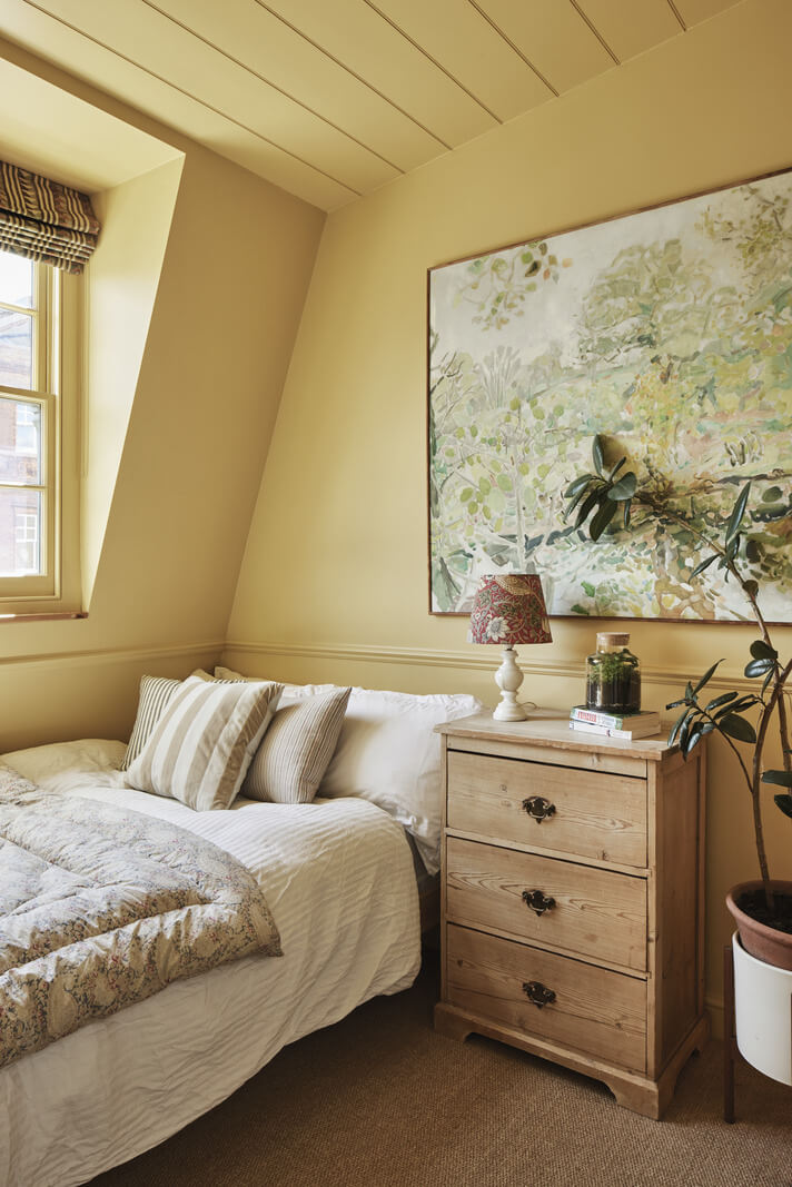 Inviting Colors in a Charming Georgian House in London 13 butter yellow bedroom with slanted ceiling