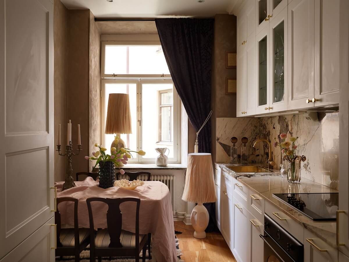 A Classic & Cozy Apartment Painted in Pastel Pink and Blue 14 classic-kitchen-white-cabinets-dining-table-nordroom
