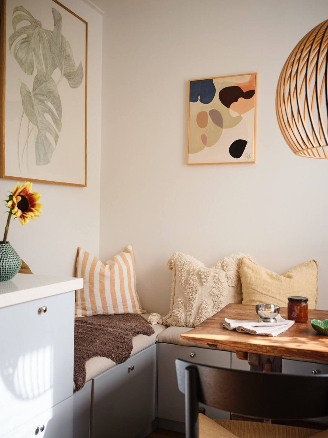 A Light Corner Apartment with a Pink Bedroom 10 corner bench kitchen