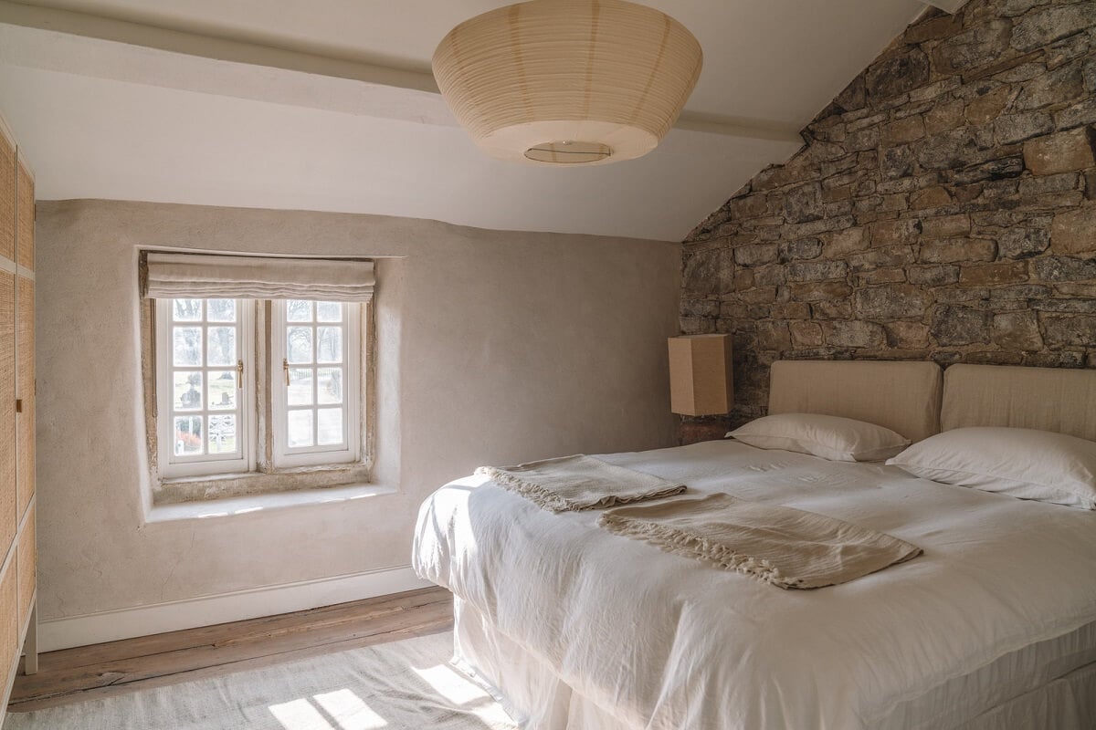 Contemporary Interiors in a Historic English House 16 cottage bedroom with stone feature wall