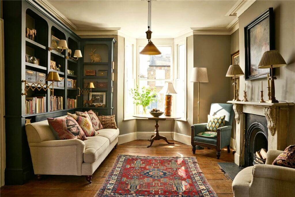 A Warm Muted Color Palette in a Victorian House 1 cozy living room with blue bookcases and bay window