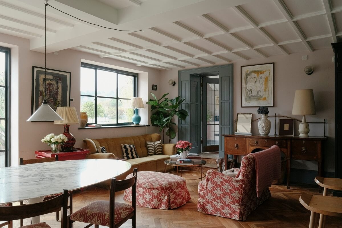 A Barn House with Vintage Decor and Exposed Beams 1 cozy open plan sitting room with colorful furniture and ice blue doors