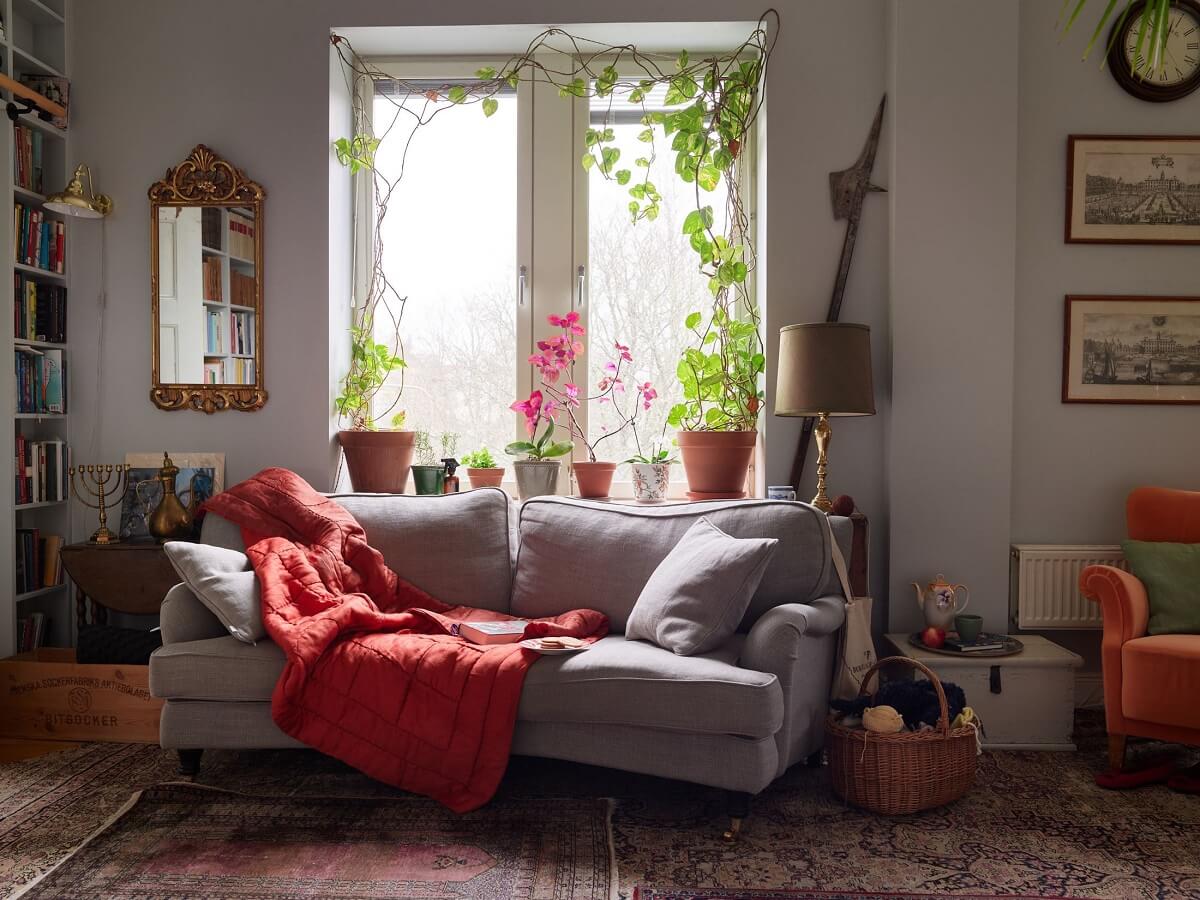 Floor-to-Ceiling Bookcases in a 1950s Swedish Home 3 cozy seating ares with rug and plants