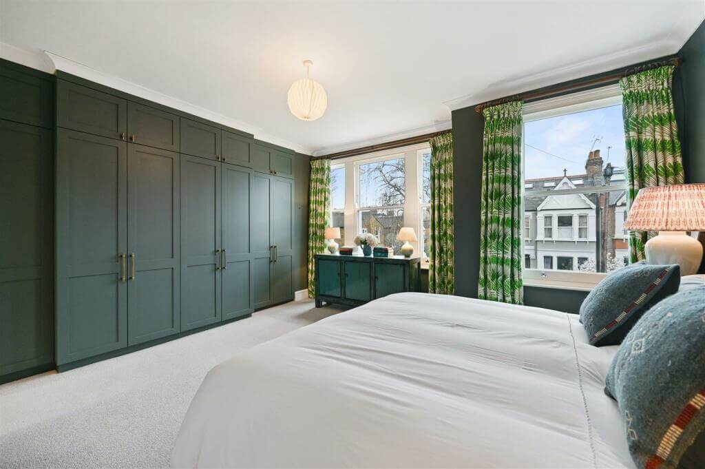 A London Family Home with Blue Color Accents 9 dark gray bedroom with built in warrobes