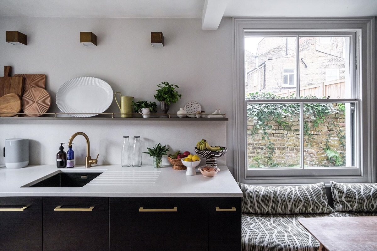 A London House Decorated in Gray and Beige Tones 11 dark kitchen with window bench