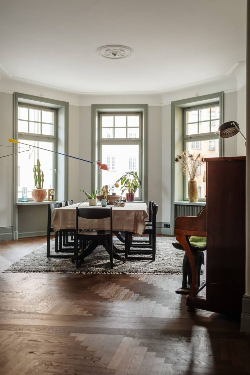 Moody Rooms in a Grand Stockholm Apartment 11 dining room with piano and bay window