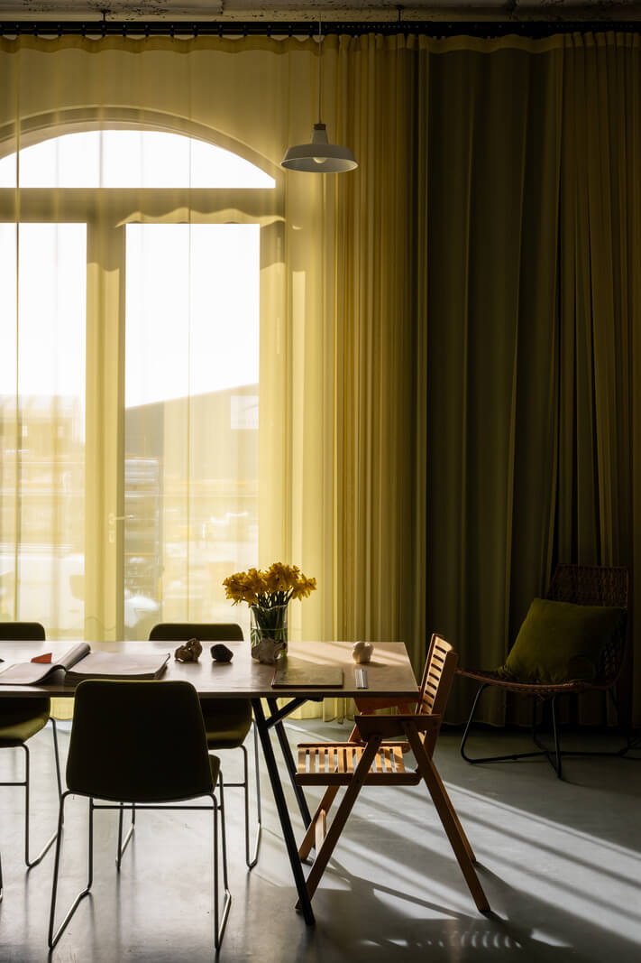 An Industrial English Loft with Yellow Color Pops 3 dining table natural light
