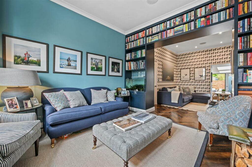 A London Family Home with Blue Color Accents 3 double living room with blue accent wall and bookcases