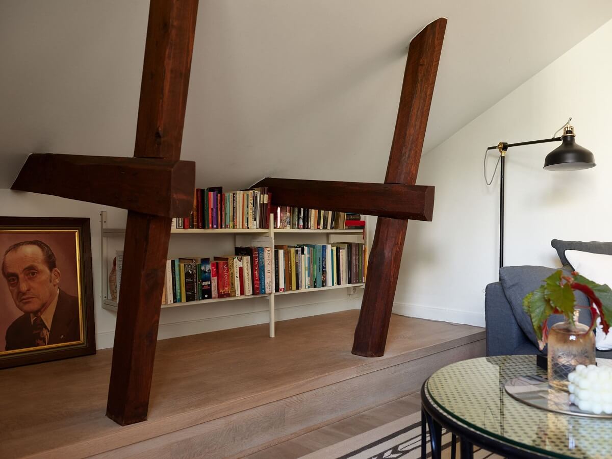 A Small Attic Apartment with a Golden Yellow Bedroom 4 exposed beams bookshelves living room