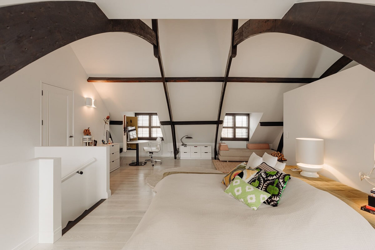 A Beautifully Renovated Dike House in The Netherlands 20 exposed wooden beams in bedroom