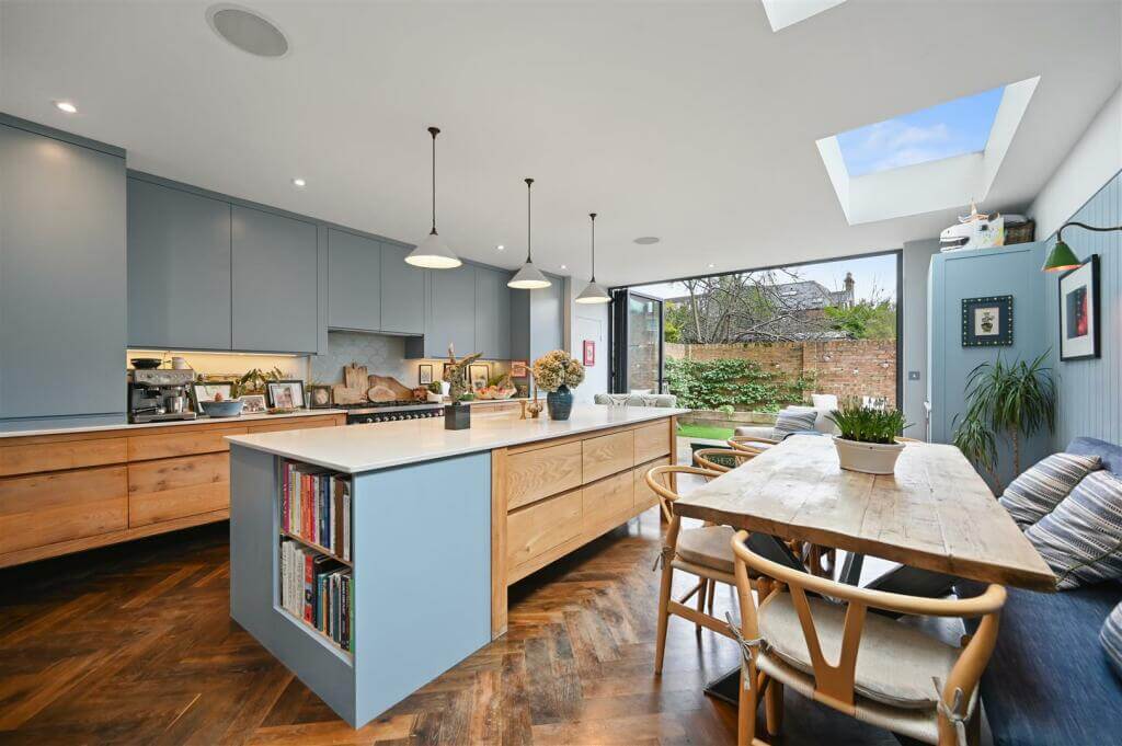 A London Family Home with Blue Color Accents 5 extended kitchen with wood cabinets and blue color accents