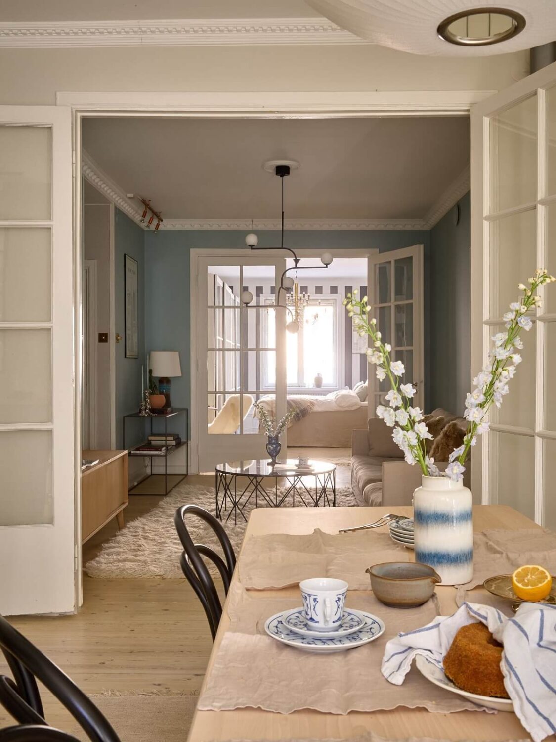 A Social Scandinavian Apartment with a Light Blue Living Room 1 front to back view of scandinavian apartment