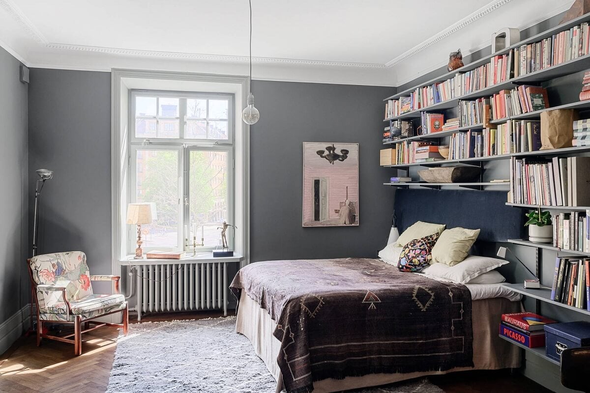 Moody Rooms in a Grand Stockholm Apartment 26 gray bedroom with bookshelves above the bed