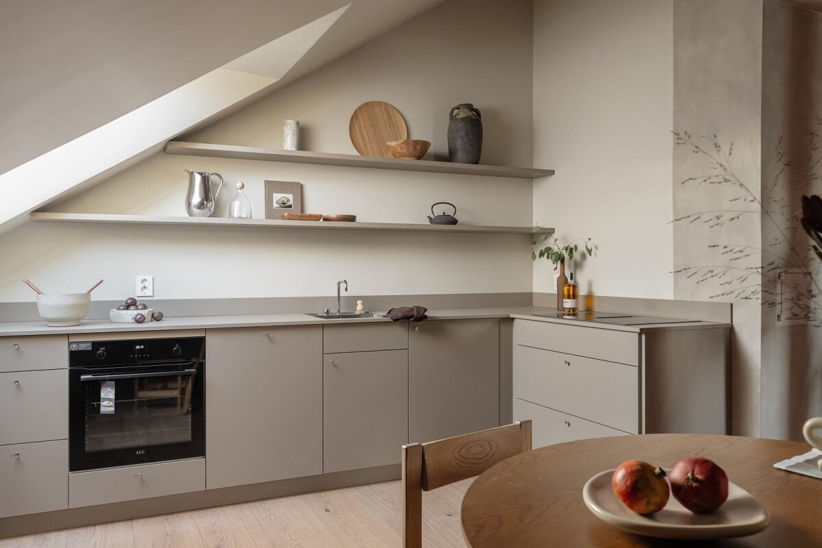 An Attic Apartment in Oslo with Exposed Wooden Beams 9 gray kitchen with shelves and slanted ceiling