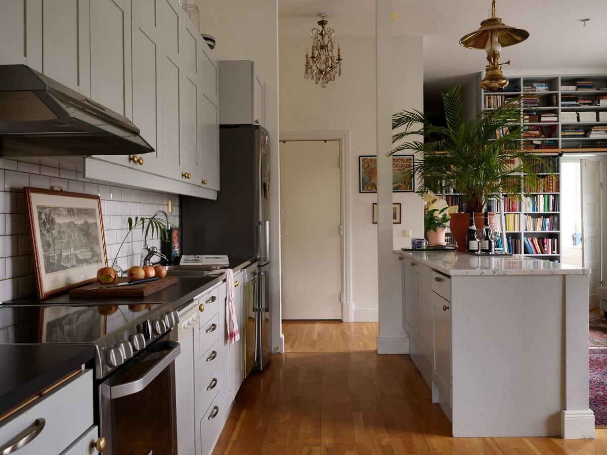 Floor-to-Ceiling Bookcases in a 1950s Swedish Home 11 gray kitchen with white tiles