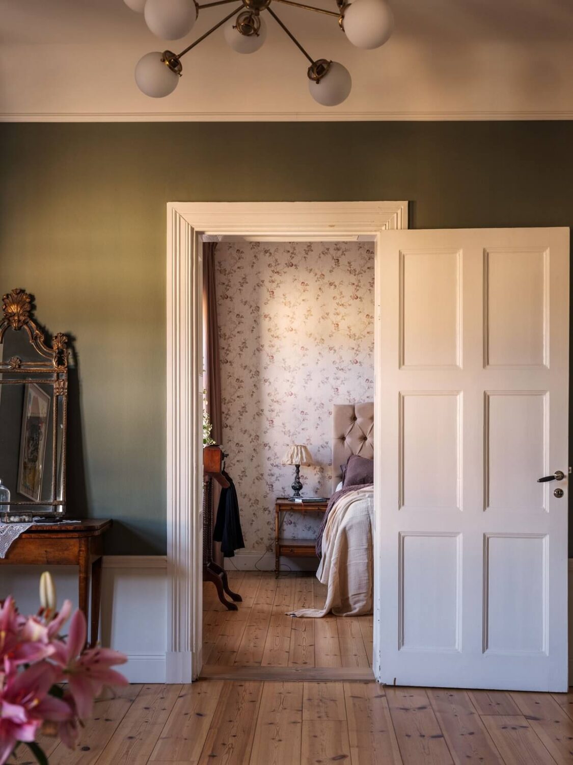 A Classic Swedish Apartment Decorated in Green and Pink Tones 19 green walls and bedroom view