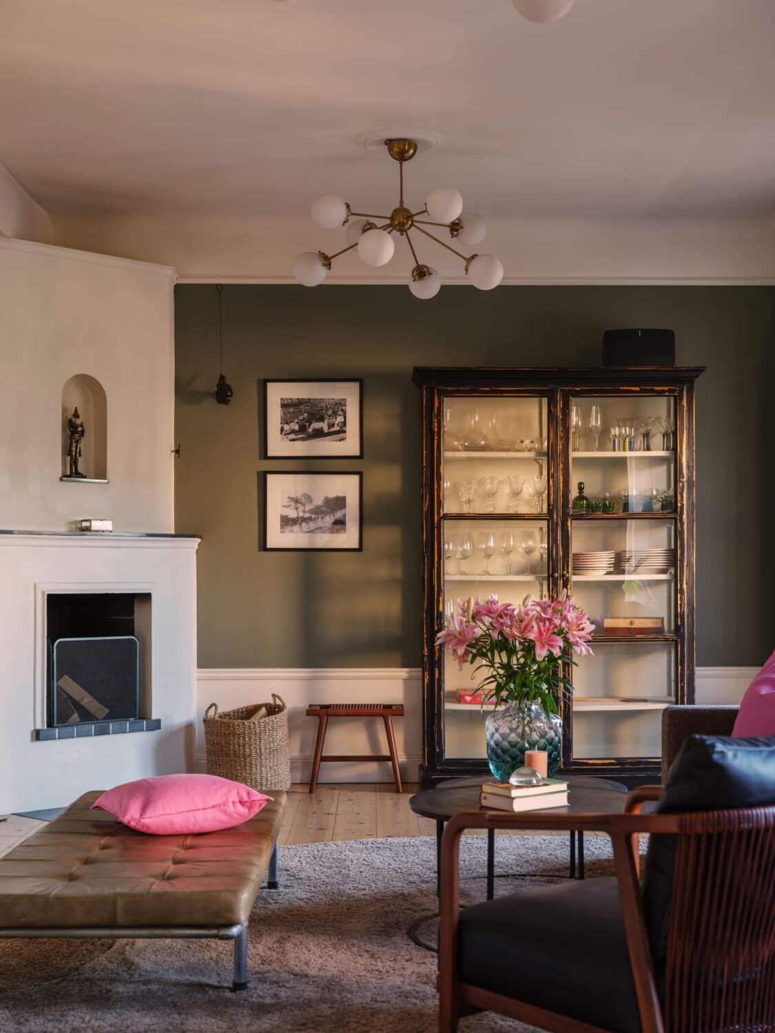 A Classic Swedish Apartment Decorated in Green and Pink Tones 2 green walls and fireplace in living room