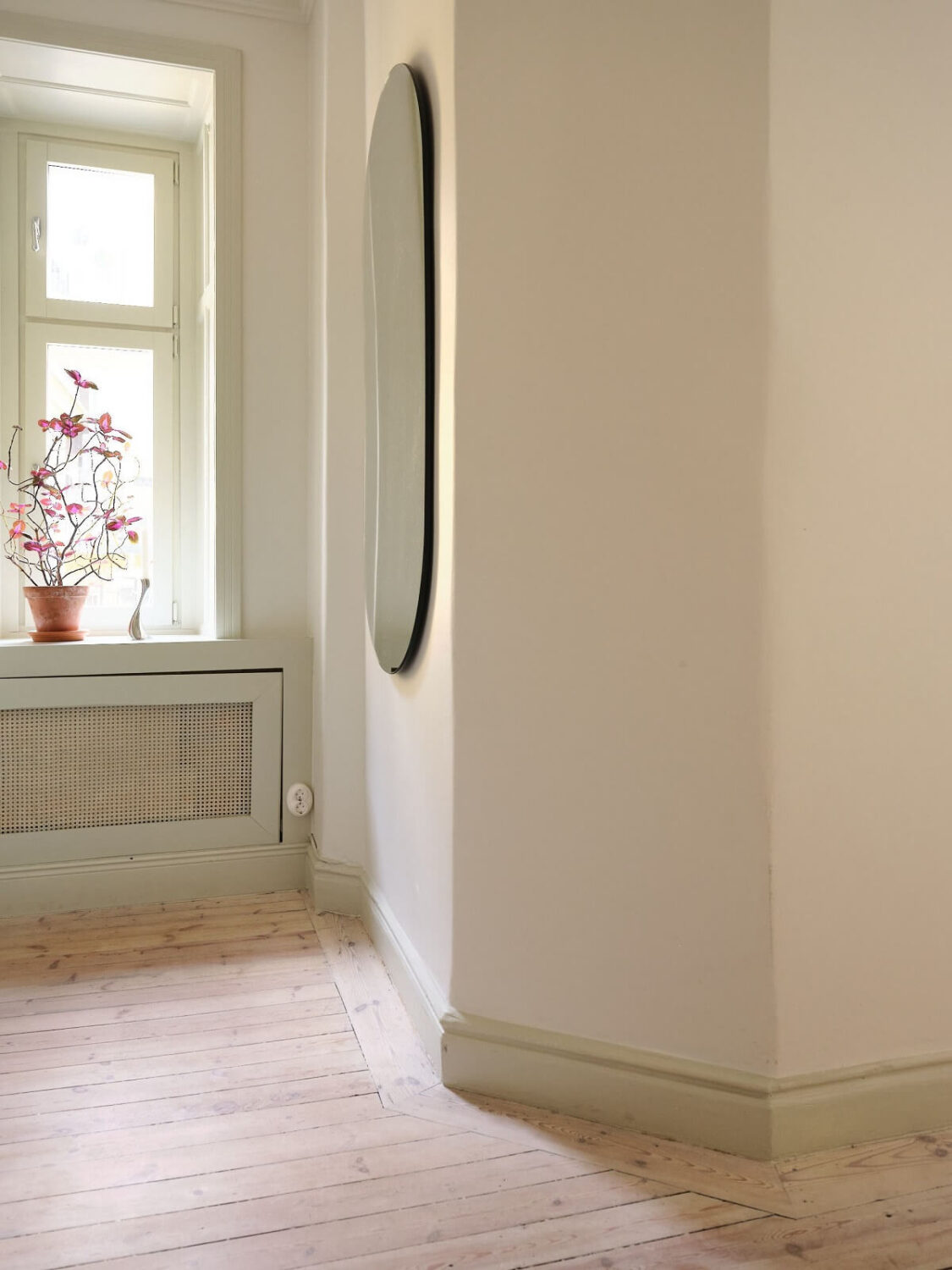 A Light Filled Duplex Apartment in Sweden 29 hallway corner with oval mirror