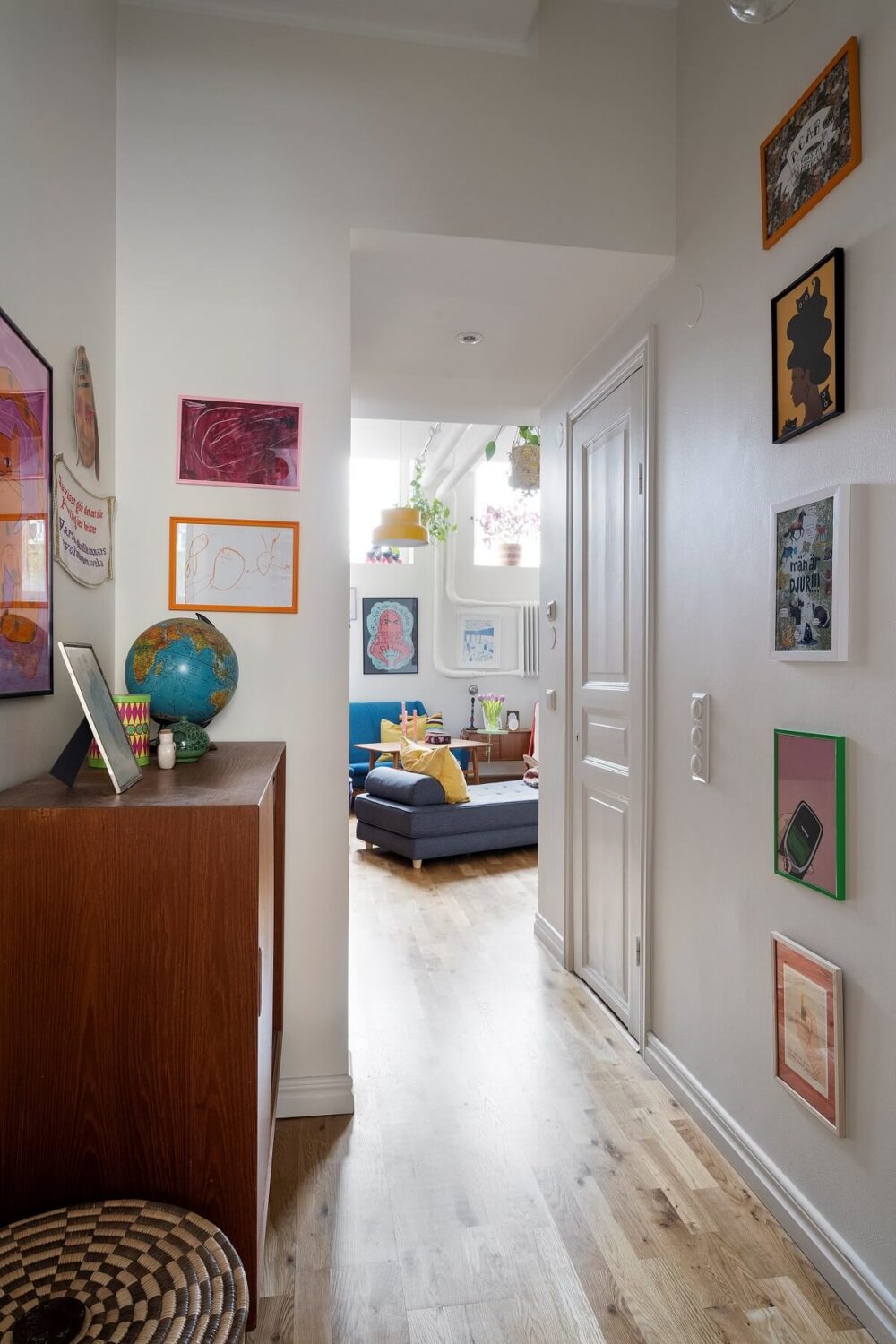 A Basement Family Apartment with Colorful Furniture and Decor 8 hallway with art