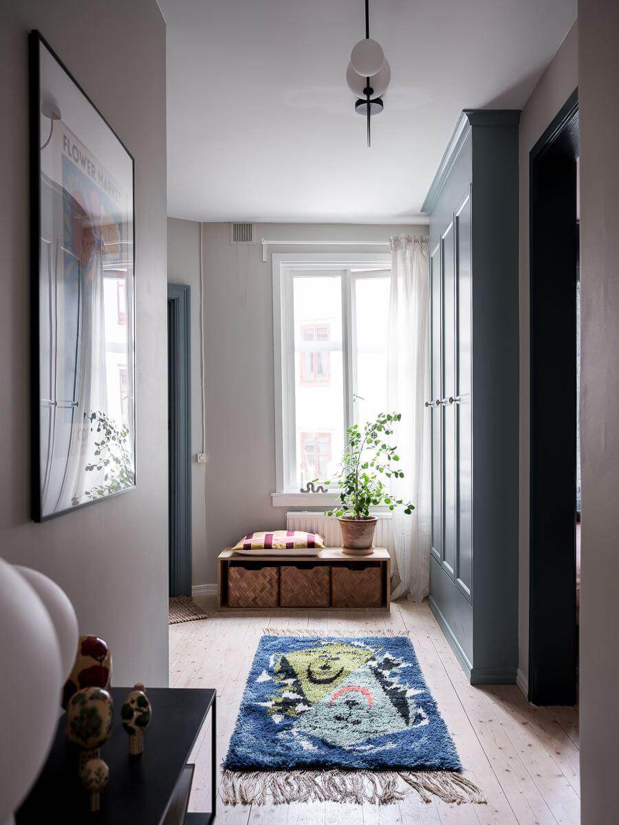 A Beautiful Color Palette in a Scandinavian Family Apartment 24 hallway with blue built in closets
