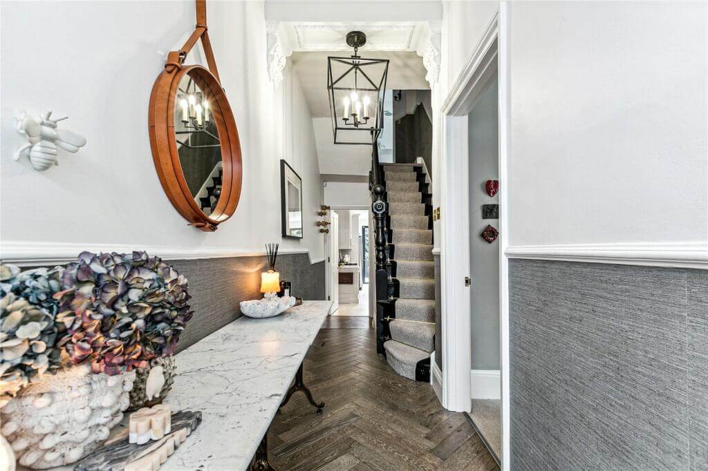 An Extended Victorian House Decorated in Gray Tones 9 hallway with gray wallpaper