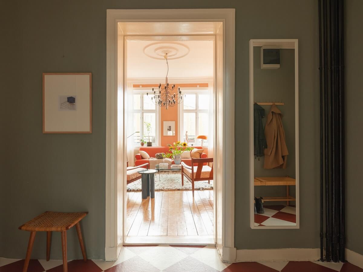 A Scandinavian Apartment with a Warm Living Room and Rounded Walls 10 hallway with large mirror