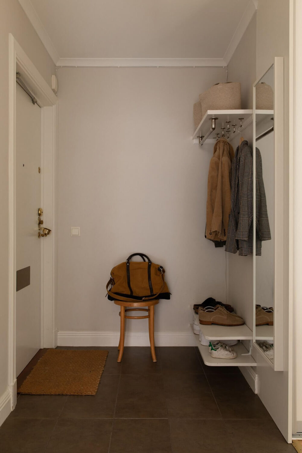 A Light Colored Swedish Apartment 21 hallway with minimalistic coat hanger and shoe storage