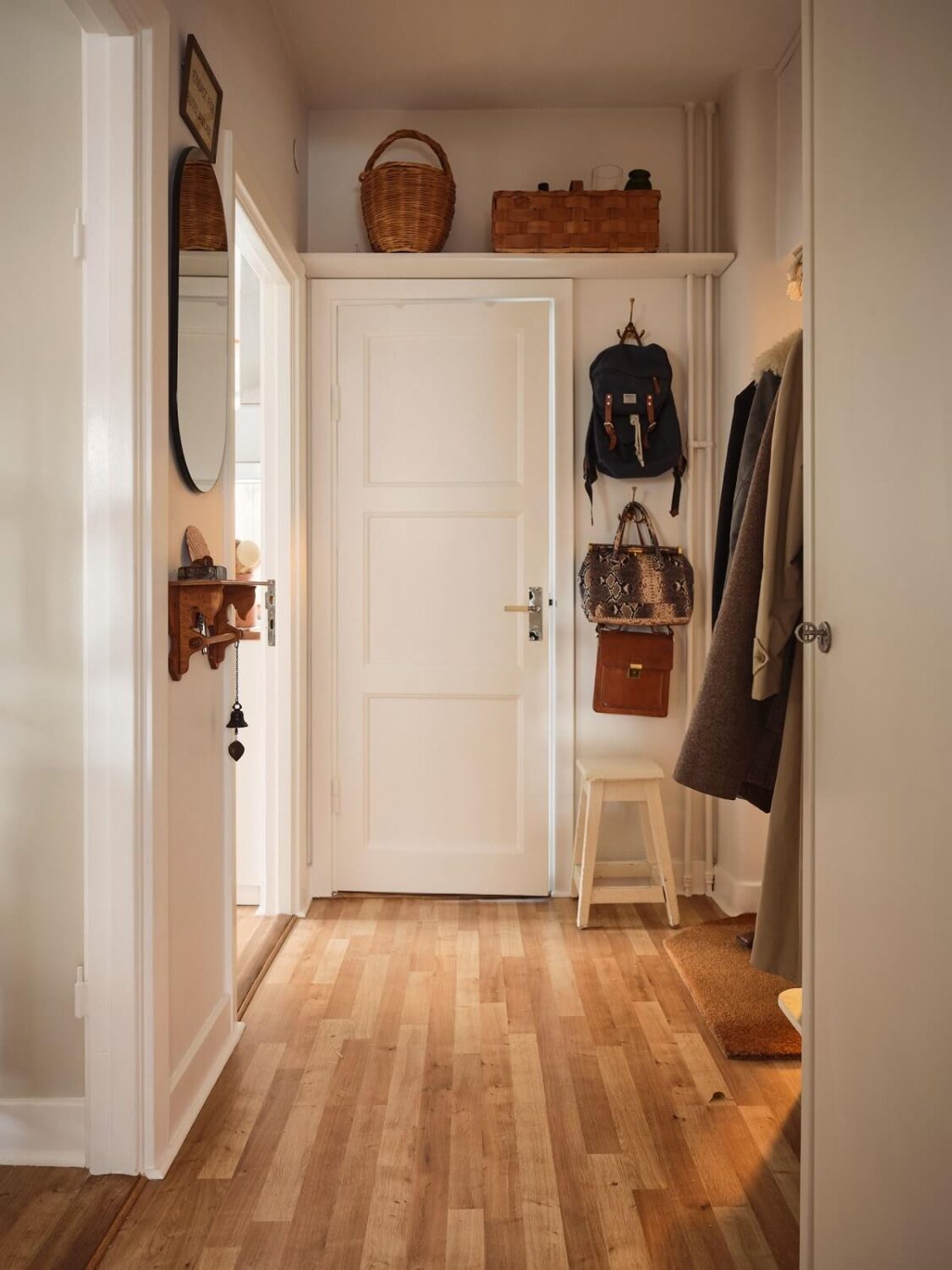 A Small Apartment with a Cozy Dining Nook 16 hallway with shelf above the door