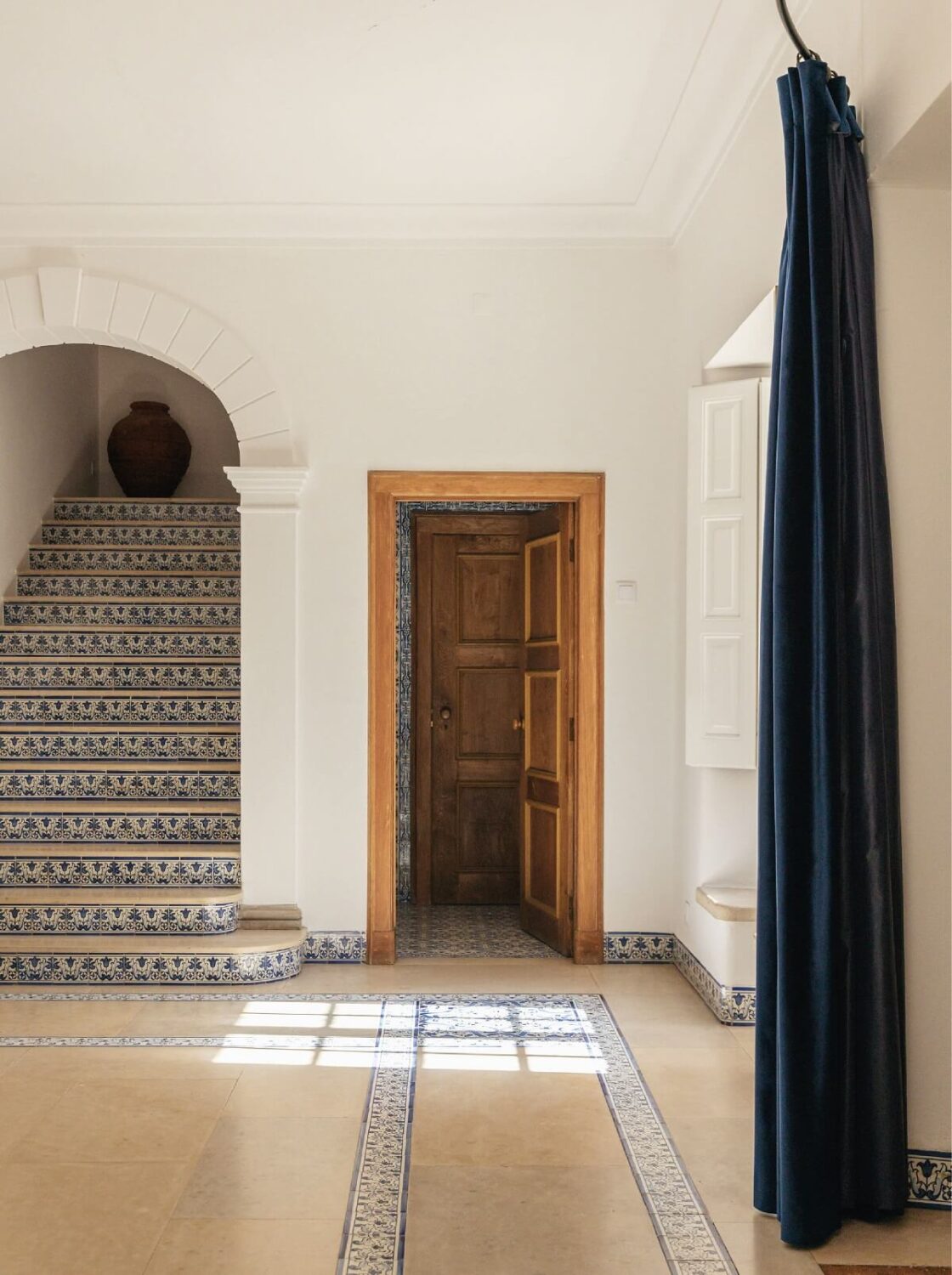 A Renovated Pink Manor House in Portugal 6 hallway with staircase and blue tiles