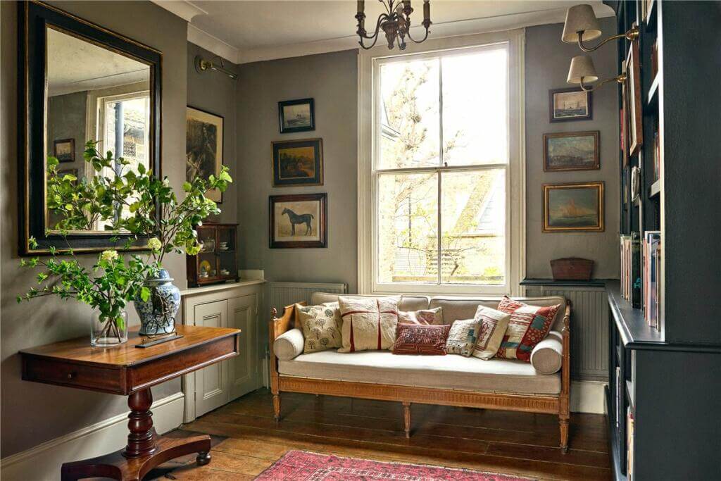 A Warm Muted Color Palette in a Victorian House 10 home library with sofa in front of the window