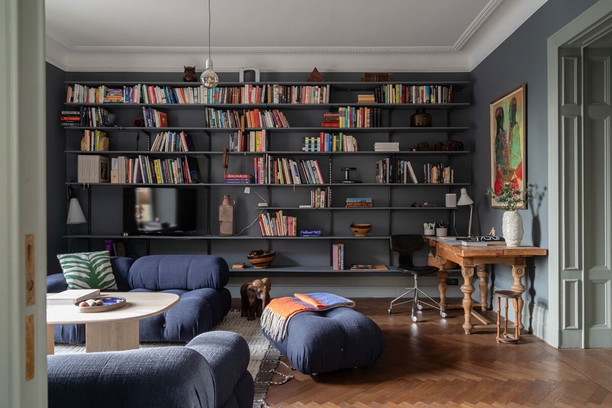 Moody Rooms in a Grand Stockholm Apartment 3 home office with dark blue walls and shelves