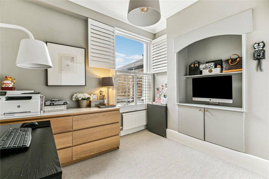 An Extended Victorian House Decorated in Gray Tones 13 home office with light gray walls