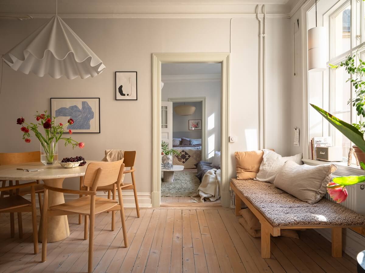 Light Rooms and Soft Color Tones in a Swedish Apartment 15 kitchen and dining room with wooden floor and bench