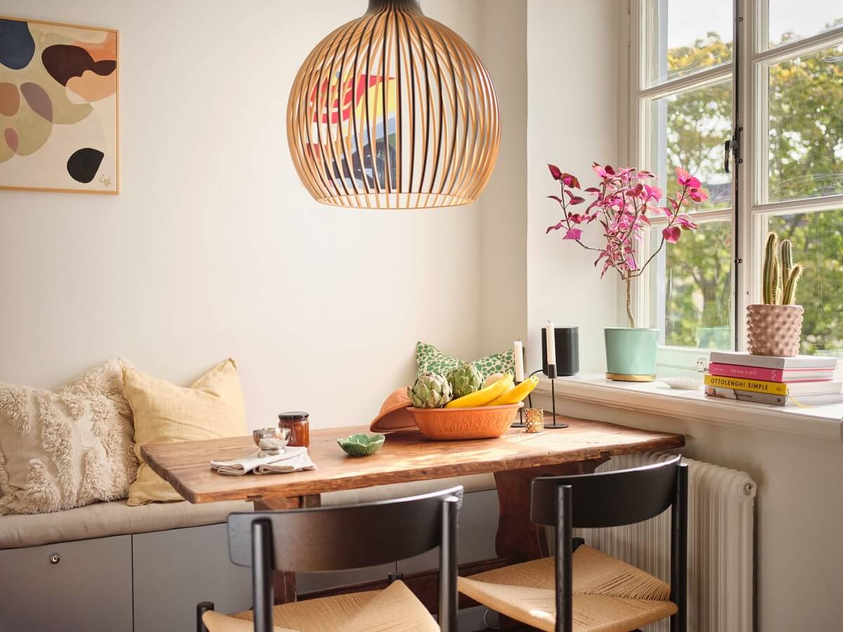 A Light Corner Apartment with a Pink Bedroom 9 kitchen breakfast table with bench