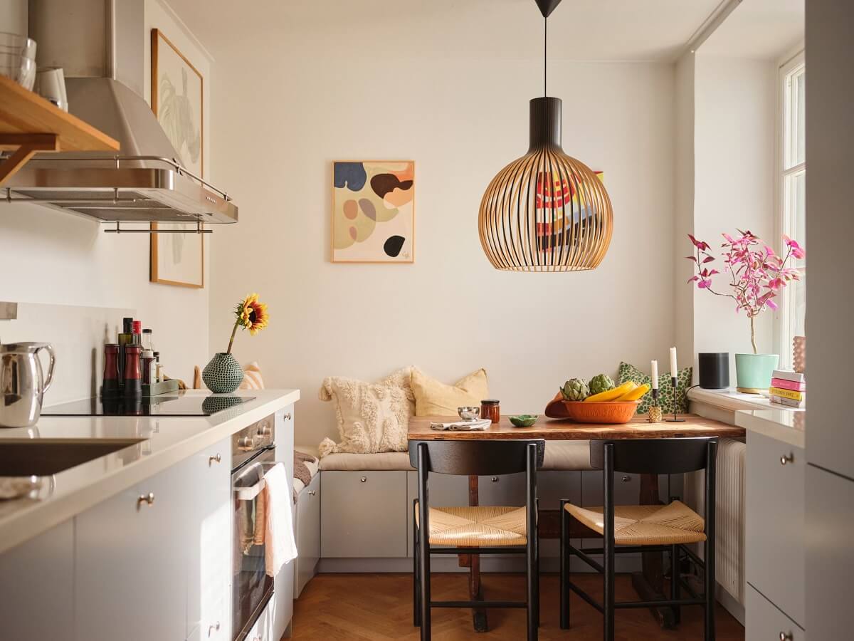 A Light Corner Apartment with a Pink Bedroom 8 kitchen light gray cabinets and breakfast nook