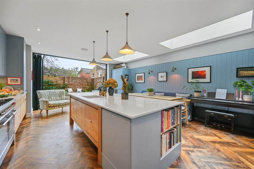 A London Family Home with Blue Color Accents 6 kitchen with blue accent wall and skylight