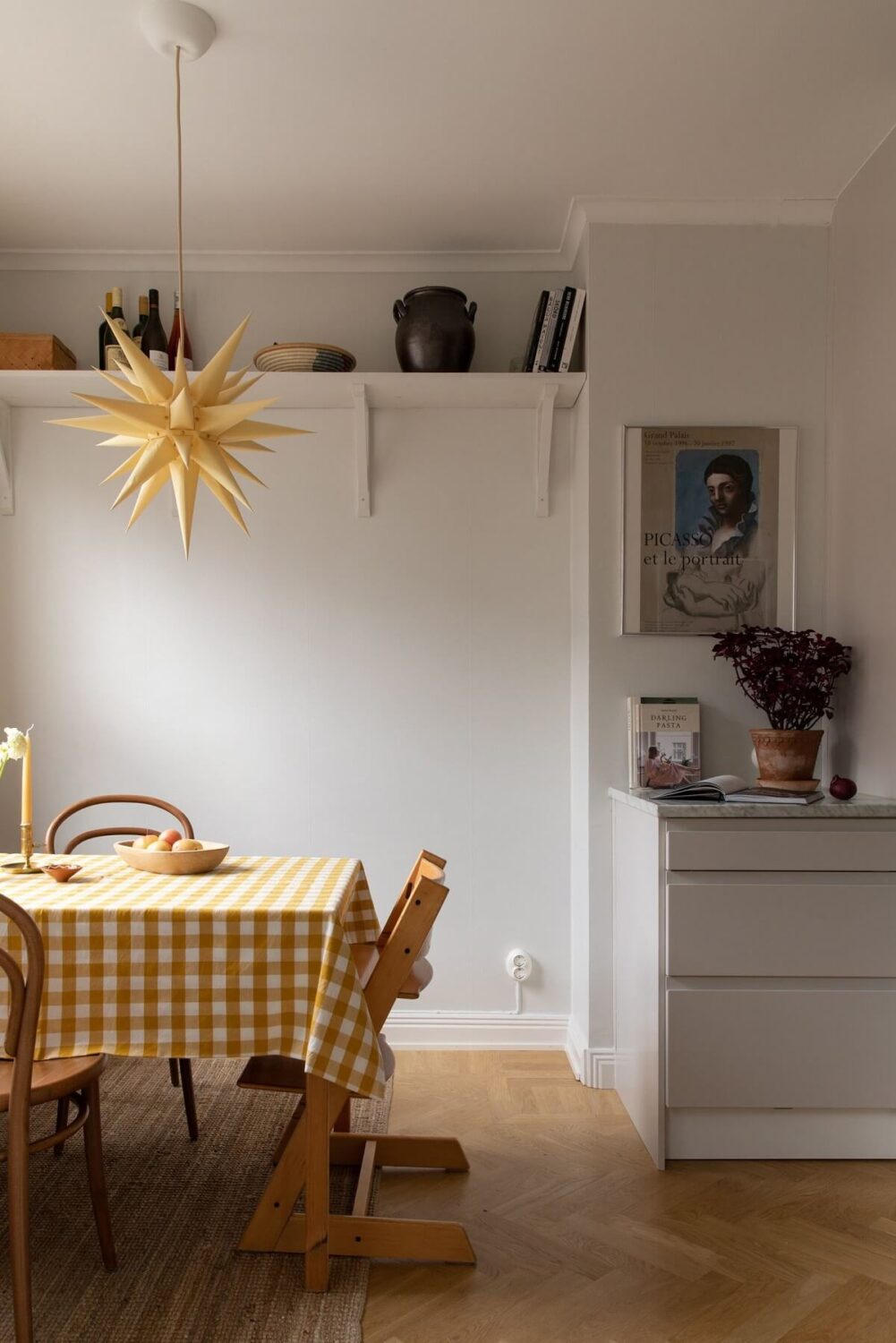 A Light Colored Swedish Apartment 13 kitchen with dining table with checkered table cloth