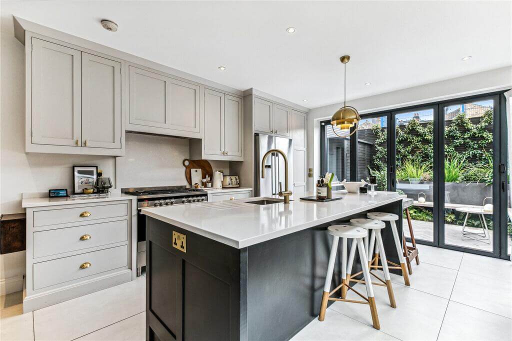 An Extended Victorian House Decorated in Gray Tones 4 kitchen with island and gray cabinets