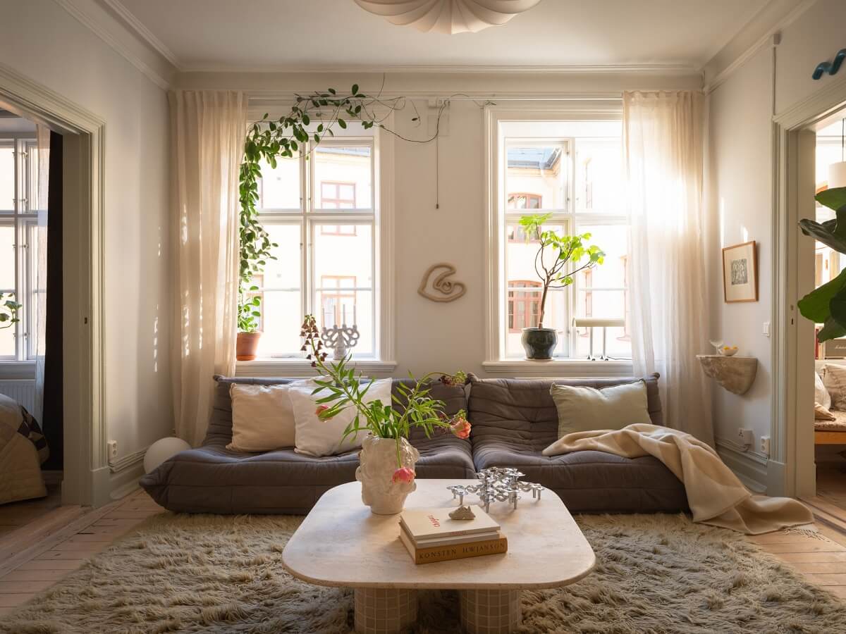 Light Rooms and Soft Color Tones in a Swedish Apartment 3 large rug and natural light in a scandinavian living room