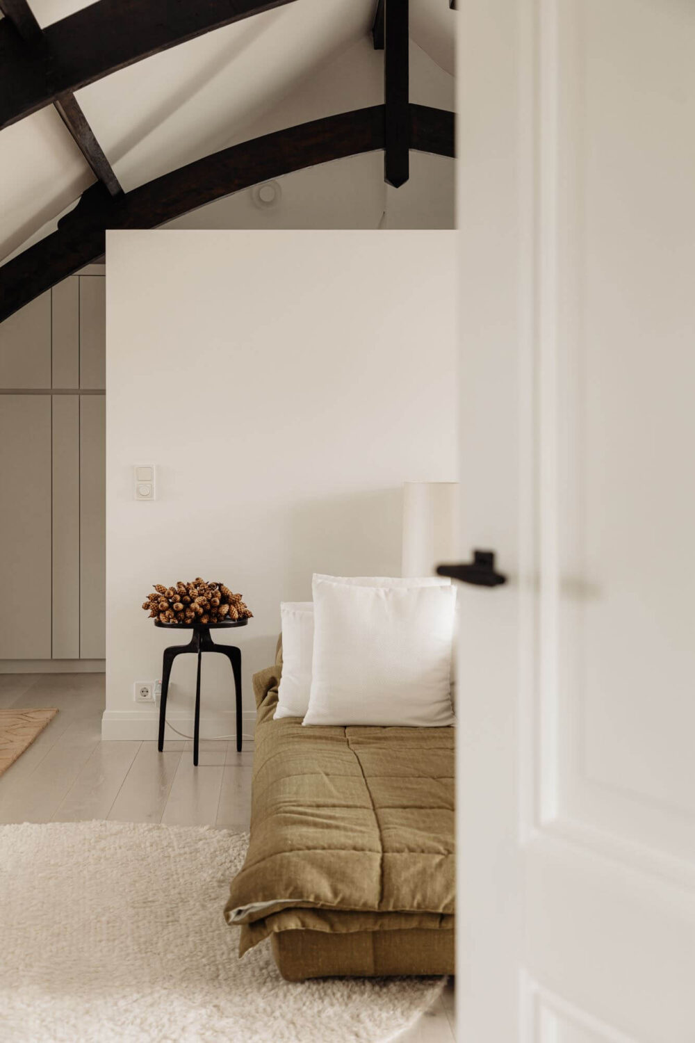 A Beautifully Renovated Dike House in The Netherlands 18 light attic bedroom with exposed beams