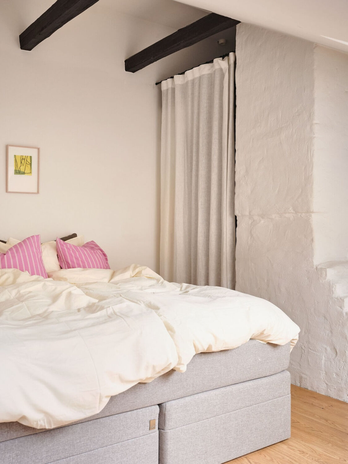 A Light Filled Duplex Apartment in Sweden 21 light attic bedroom with wooden beams