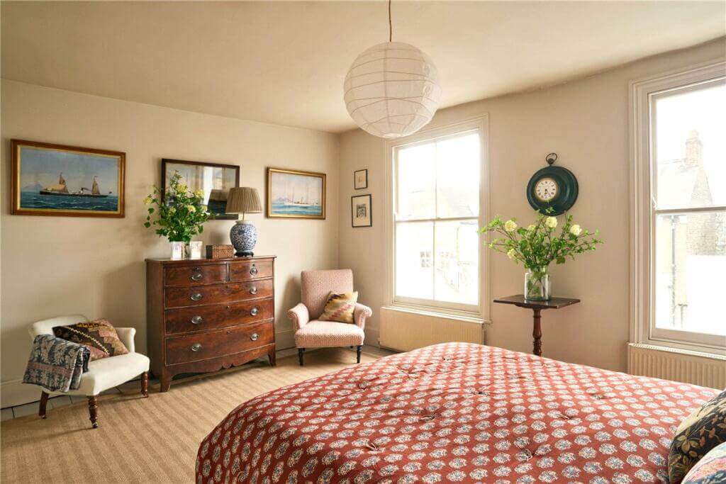 A Warm Muted Color Palette in a Victorian House 29 light bedroom with antique dresser